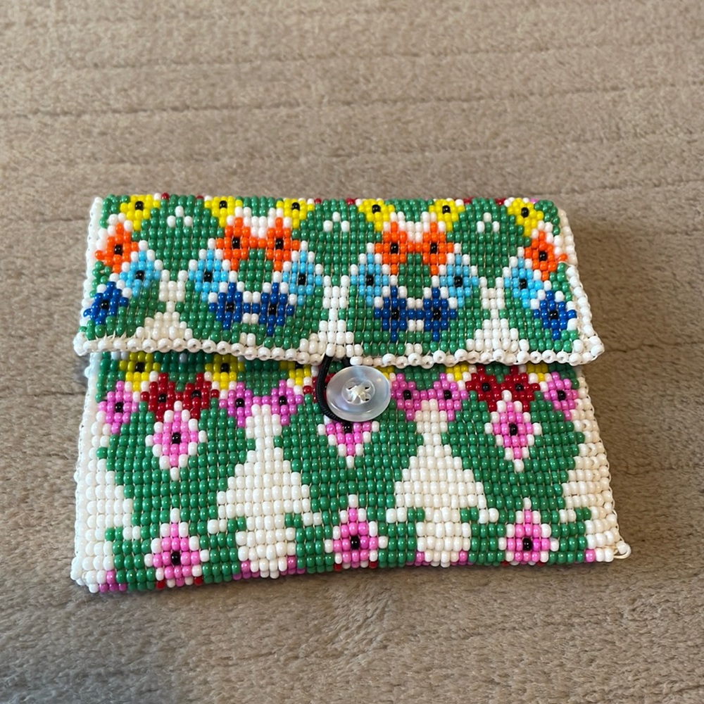Hand beaded white leather coin/trinket wallet. Never used, beautiful artwork.